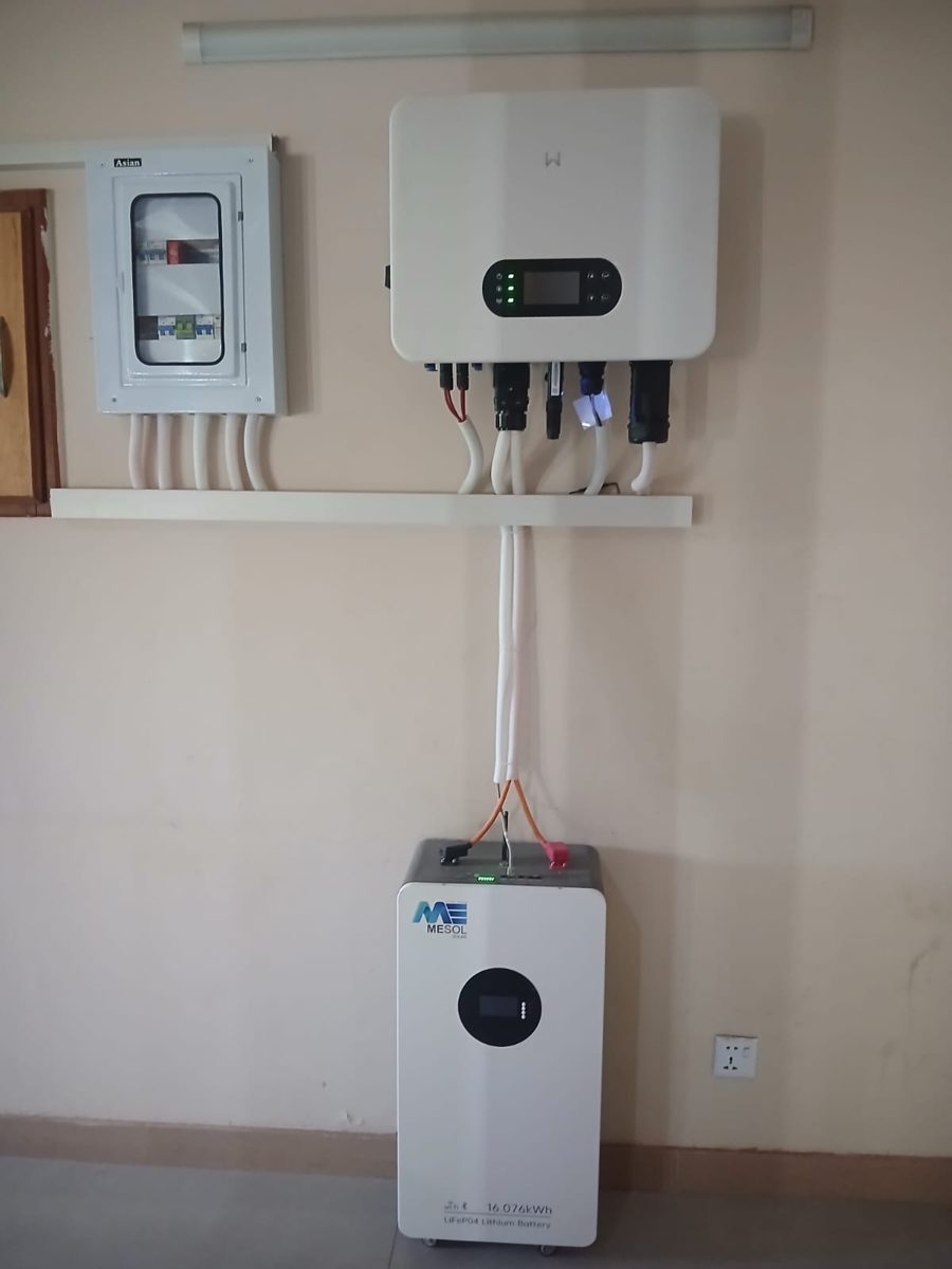 MESOL Infinity 16 kWh battery under a wall-mounted hybrid inverter in a home